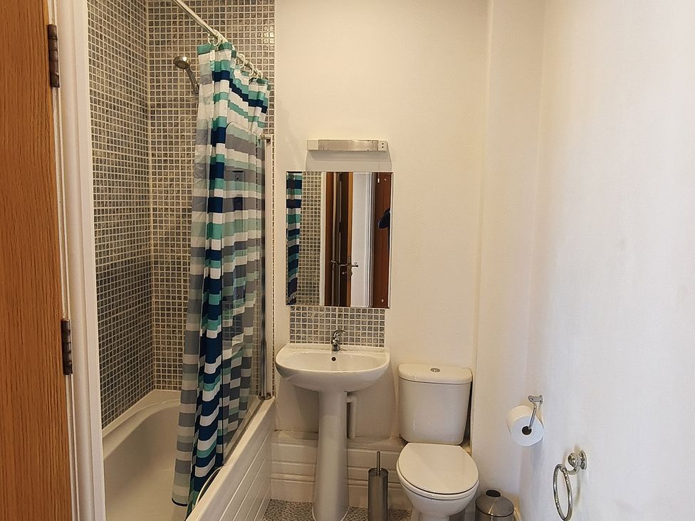 A bathroom with a shower, bathtub, toilet, and sink at Cardiff Apartment, sleeps 6, Castle and Stadium nearby Cardiff