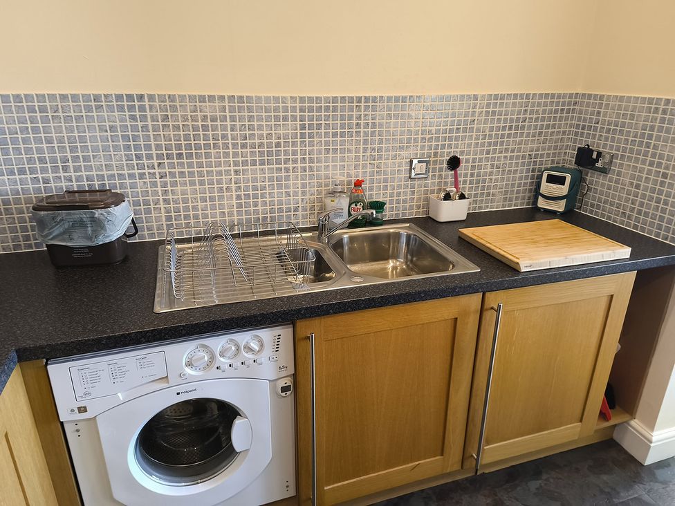 A kitchen with a sink and washing machine at Cardiff Apartment, sleeps 6, Castle and Stadium nearby, Cardiff