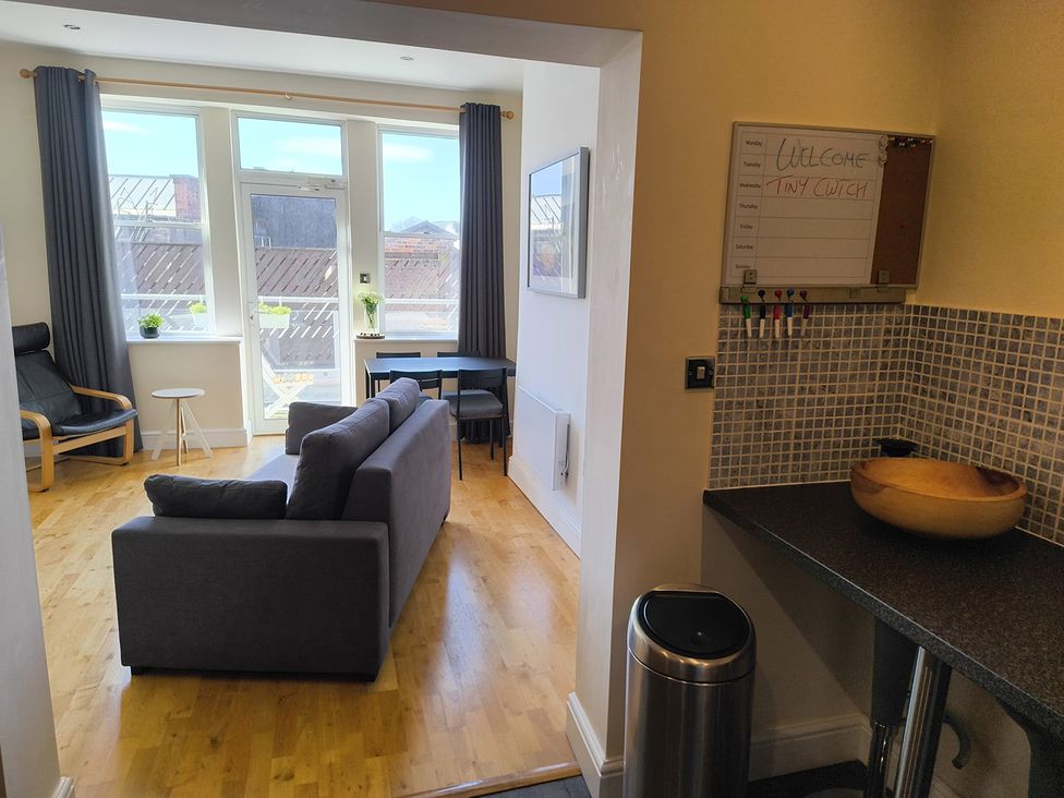 A living room with a sofa and armchair at Cardiff Apartment, sleeps 6, Castle and Stadium nearby Cardiff