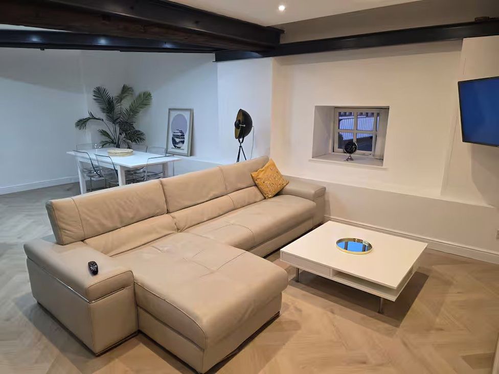 A living room with a sofa and coffee table at Liverpool Penthouse, sleeps 8, Liverpool