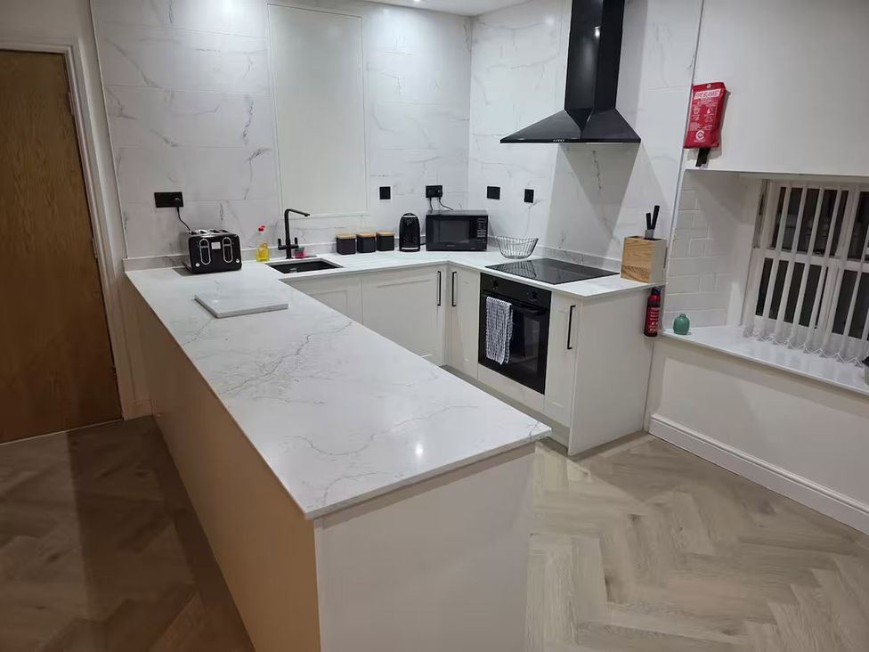 A kitchen with appliances and a counter at Liverpool Penthouse, sleeps 8, Liverpool