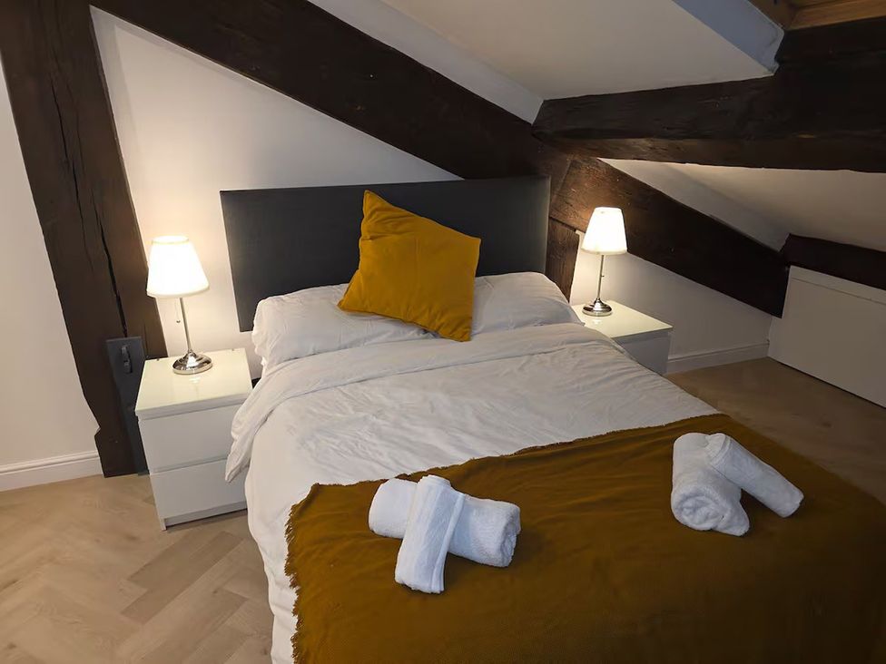 A bedroom with a bed and nightstand at Liverpool Penthouse, sleeps 8, Liverpool