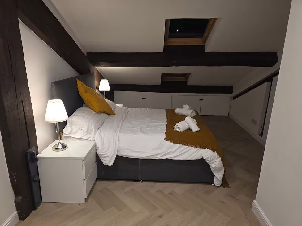 A bedroom with a bed and bedside lamp at Liverpool Penthouse, sleeps 8 Liverpool