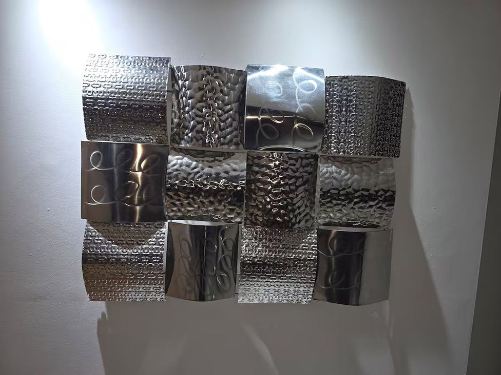 A decorative metal wall art piece with abstract patterns at Liverpool Penthouse, sleeps 8 Liverpool