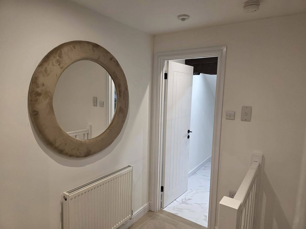 A hallway with a mirror and door at Liverpool Penthouse, sleeps 8 Liverpool