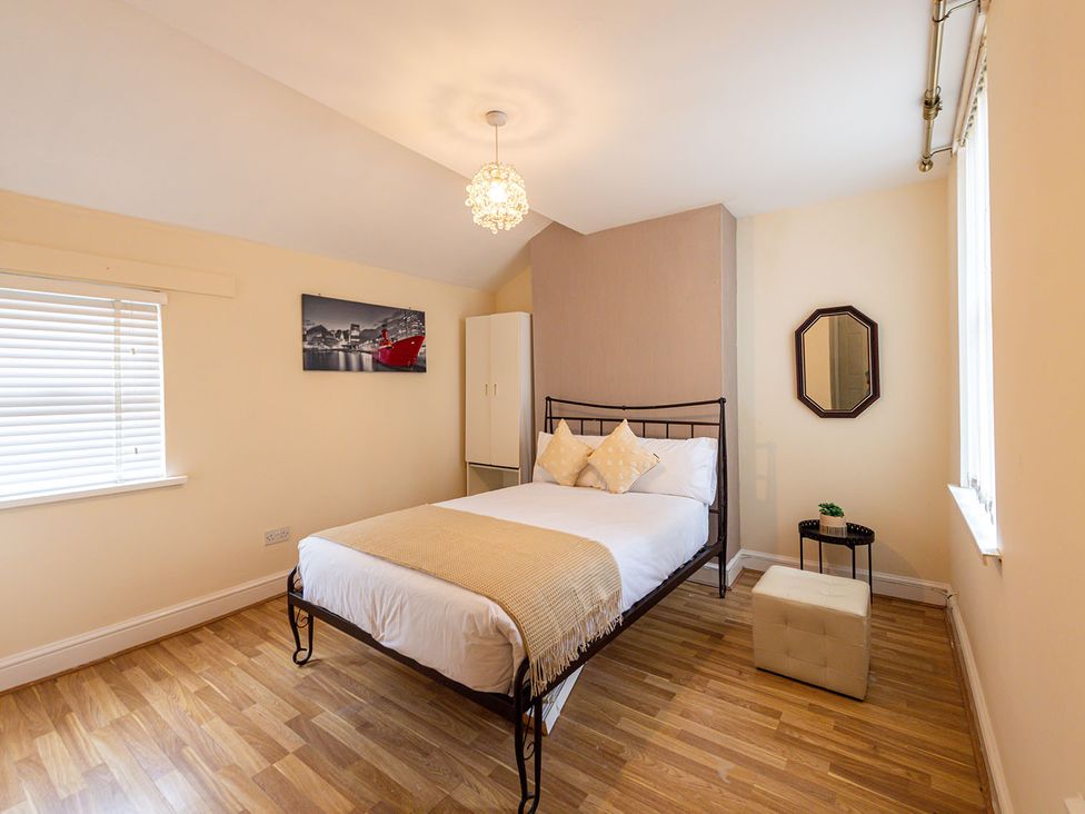 A bedroom with a bed and wardrobe at 5 Bed House, sleeping 10 in the City Centre, Liverpool