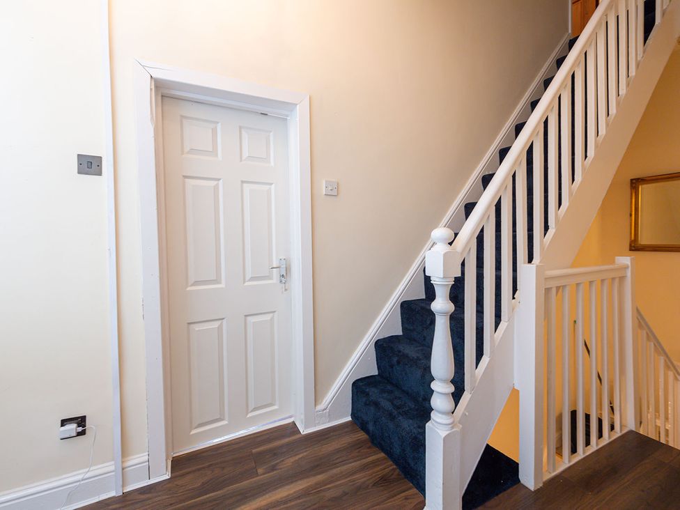 A hallway with stairs and a door at 5 Bed House, sleeping 10 in the City Centre, Liverpool
