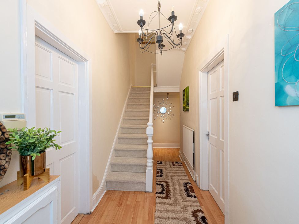 A hallway with a staircase and chandelier at 5 Bed House, sleeping 10 in the City Centre, Liverpool