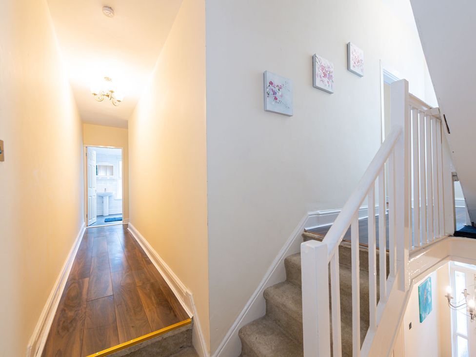 A hallway with a staircase and a door at 5 Bed House, sleeping 10 in the City Centre, Liverpool