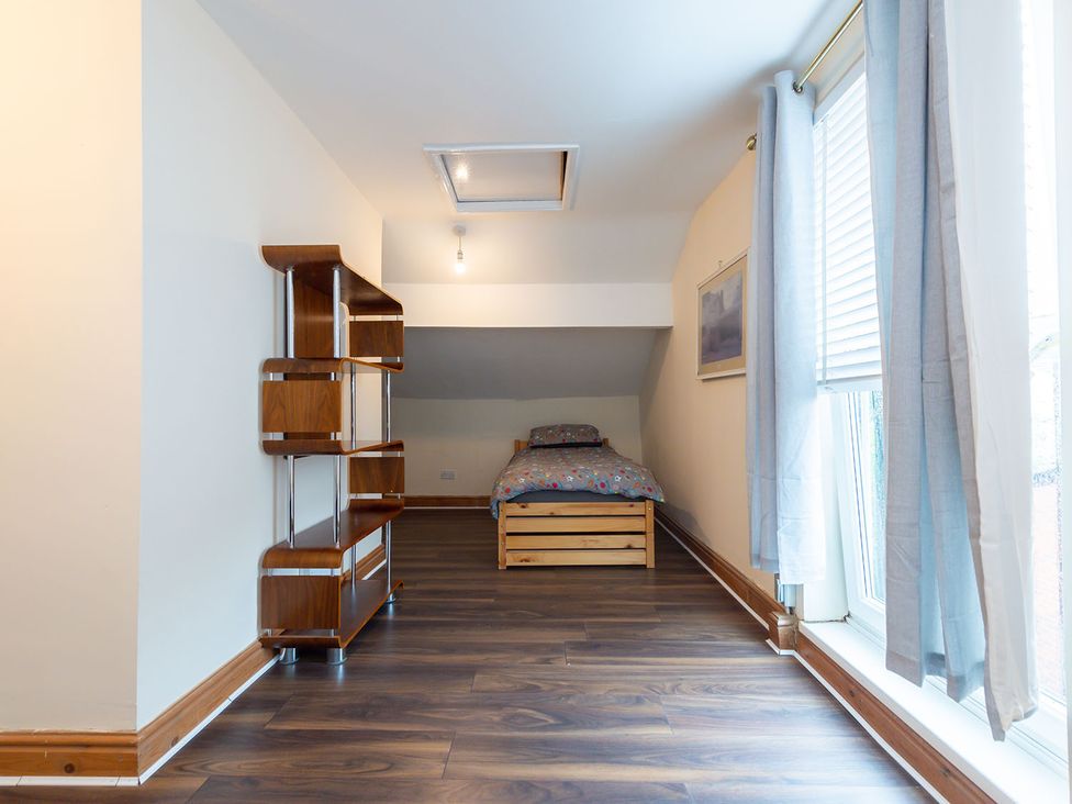 A bedroom with a bed and shelf at 5 Bed House, sleeping 10 in the City Centre, Liverpool