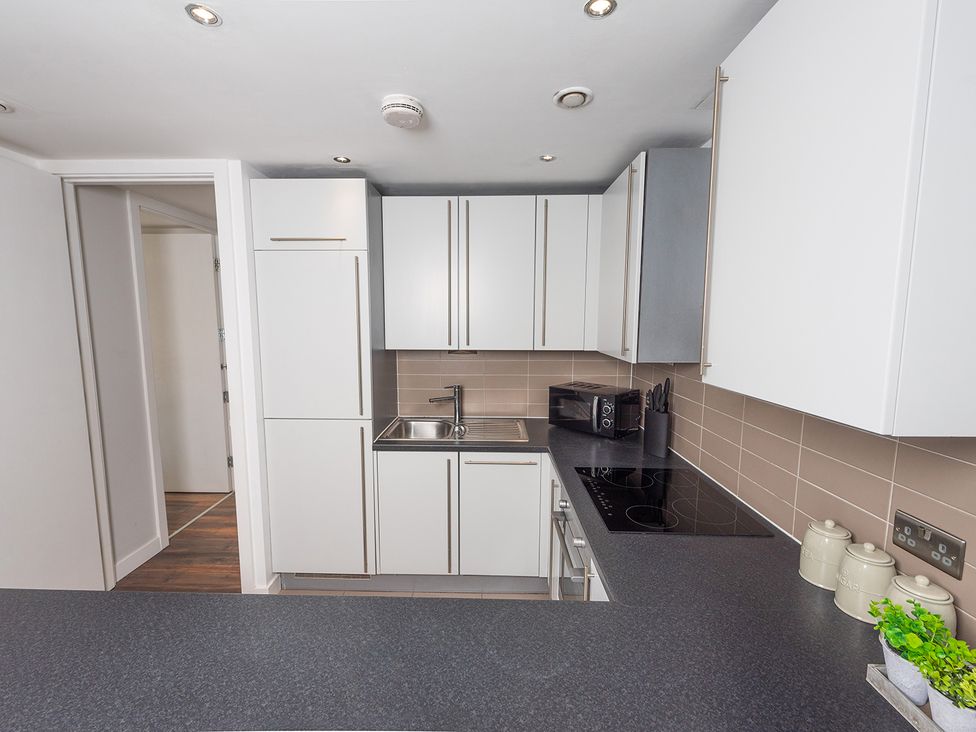 A kitchen with a sink and microwave at City Centre Apartment, 2 bed with Free Parking, Liverpool