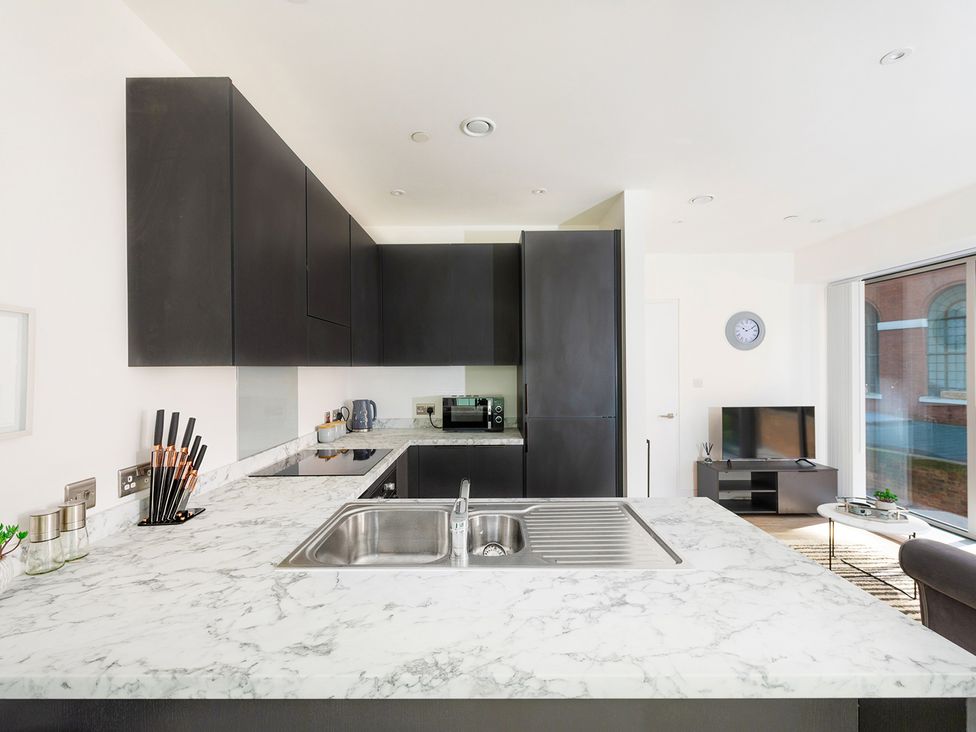 A kitchen with cabinets and a sink at Luxury City Centre Apartment, Prime Location Liverpool