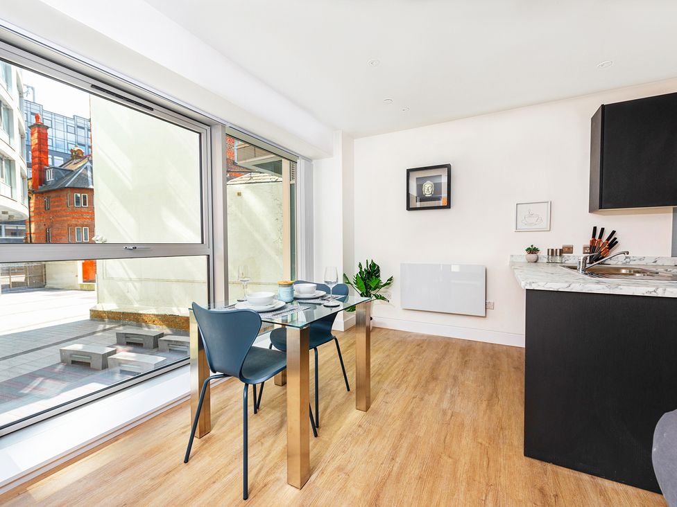 A dining room with a glass table and chairs at Luxury City Centre Apartment, Prime Location Liverpool
