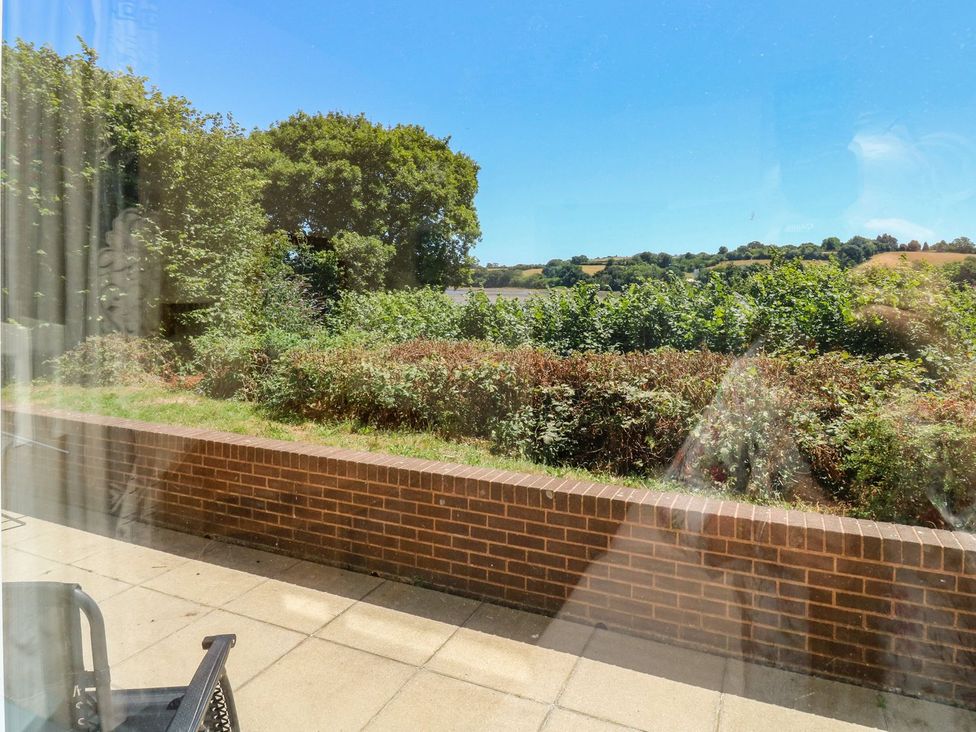 A view of greenery and a brick wall at Willow in Kingsteignton
