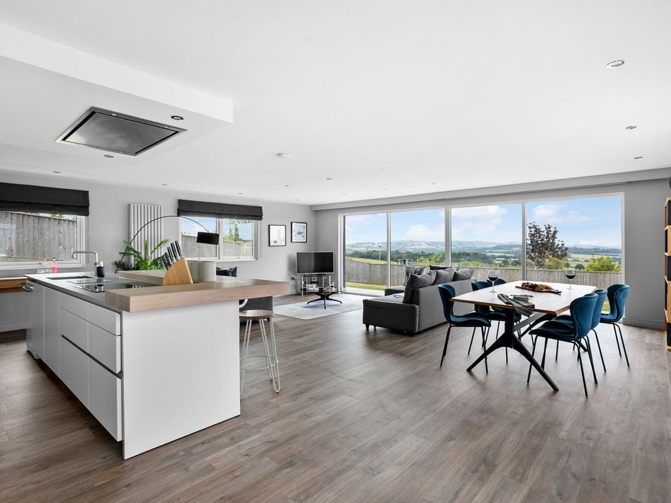 A kitchen and living room with a view at Huxham View & Annex Kingsteignton