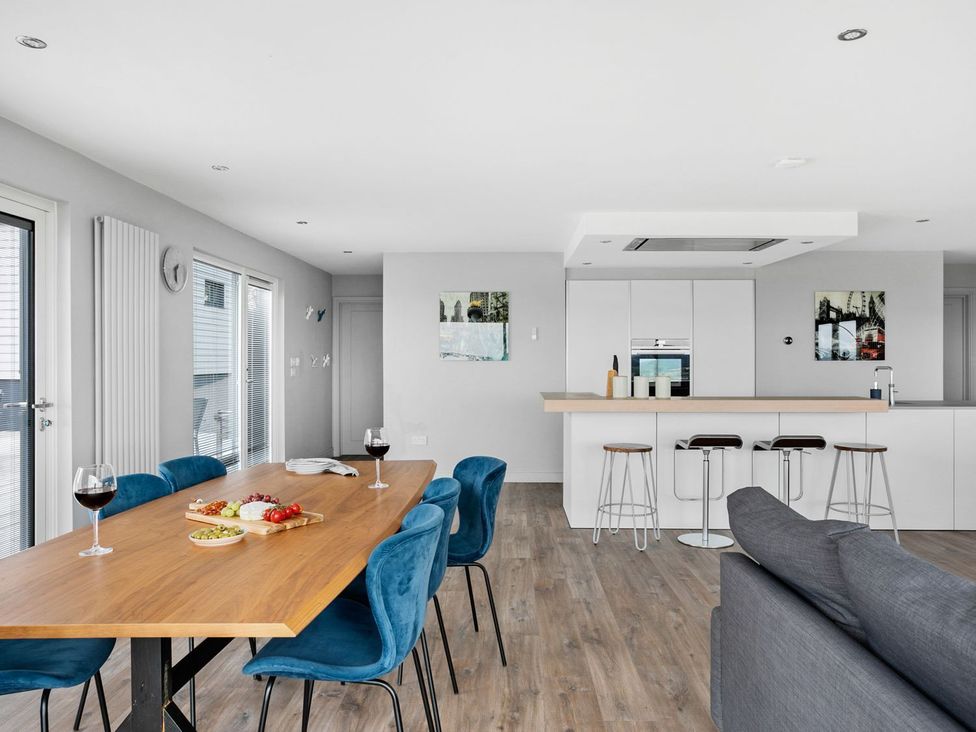 A dining room with a table and chairs at Huxham View & Annex Kingsteignton