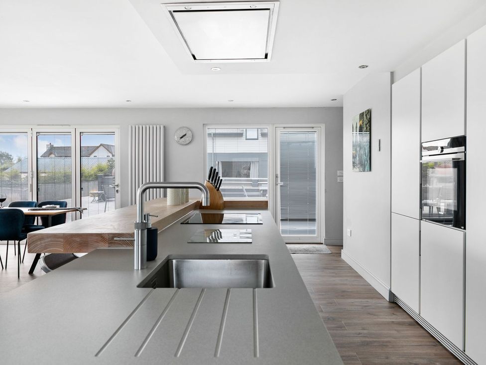 A kitchen with a sink and a kitchen island at Huxham View & Annex in Kingsteignton