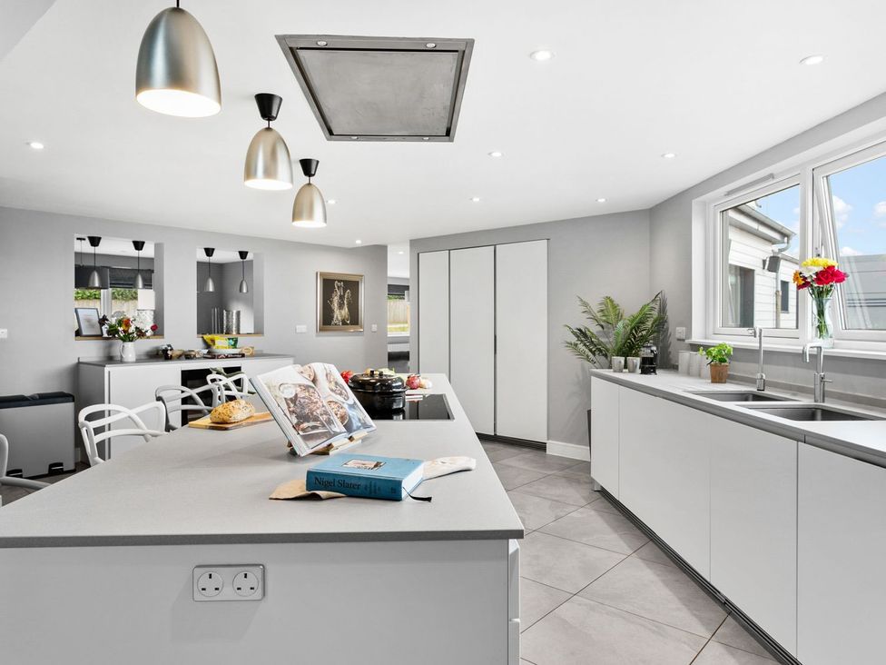A kitchen with a center island and modern fixtures at Huxham View & Annex in Kingsteignton