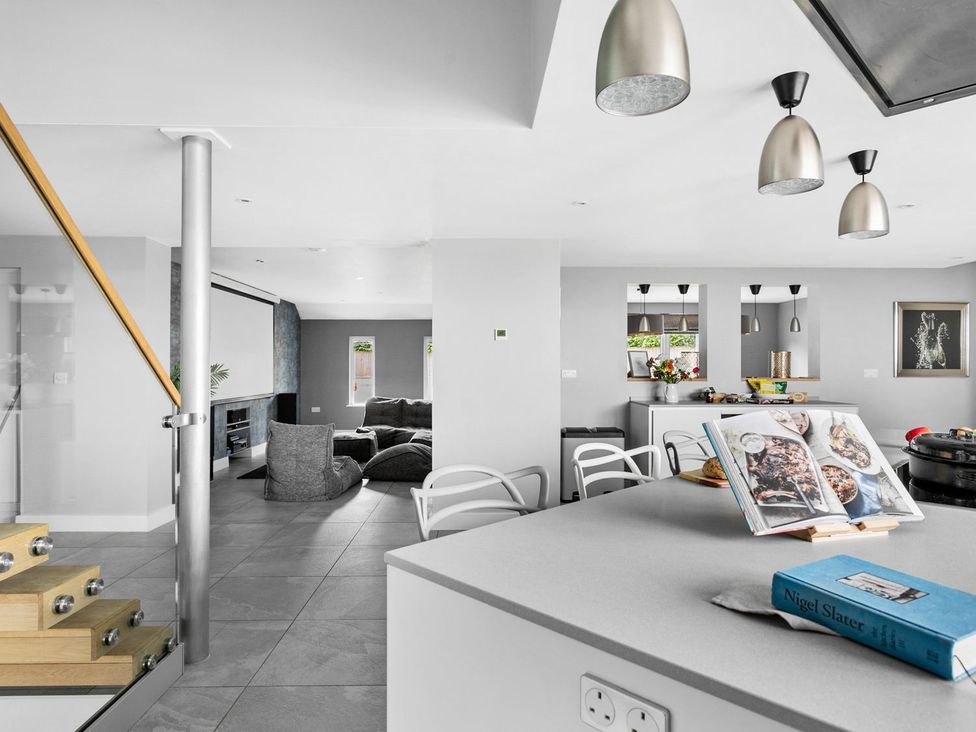 A kitchen with a sofa and television at Huxham View & Annex in Kingsteignton
