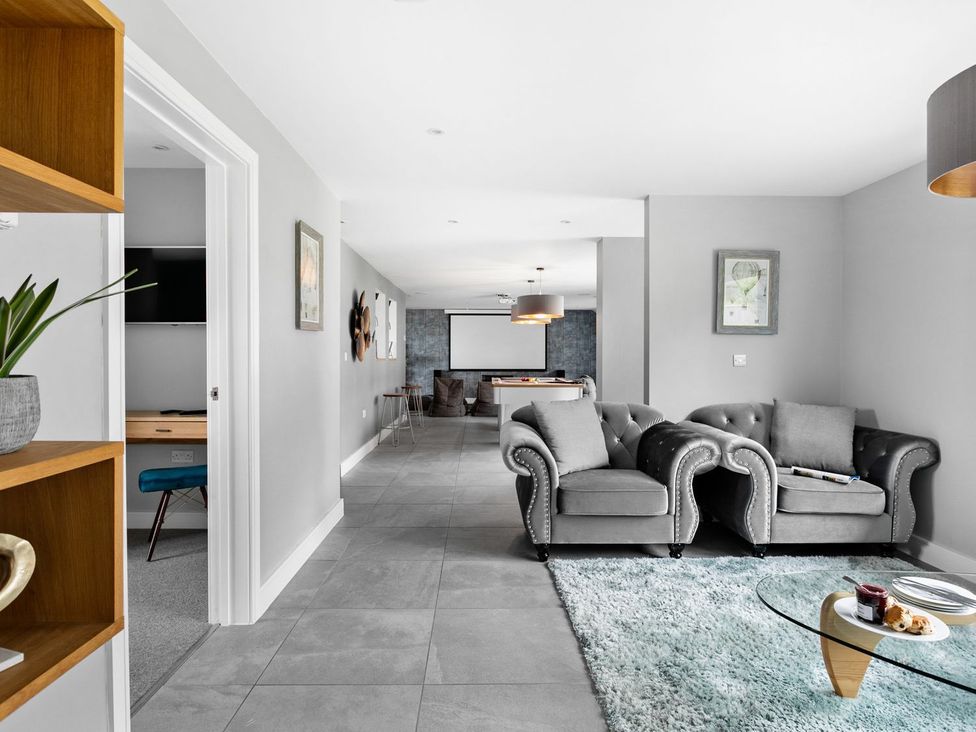 A living room with sofas and a coffee table at Huxham View & Annex in Kingsteignton
