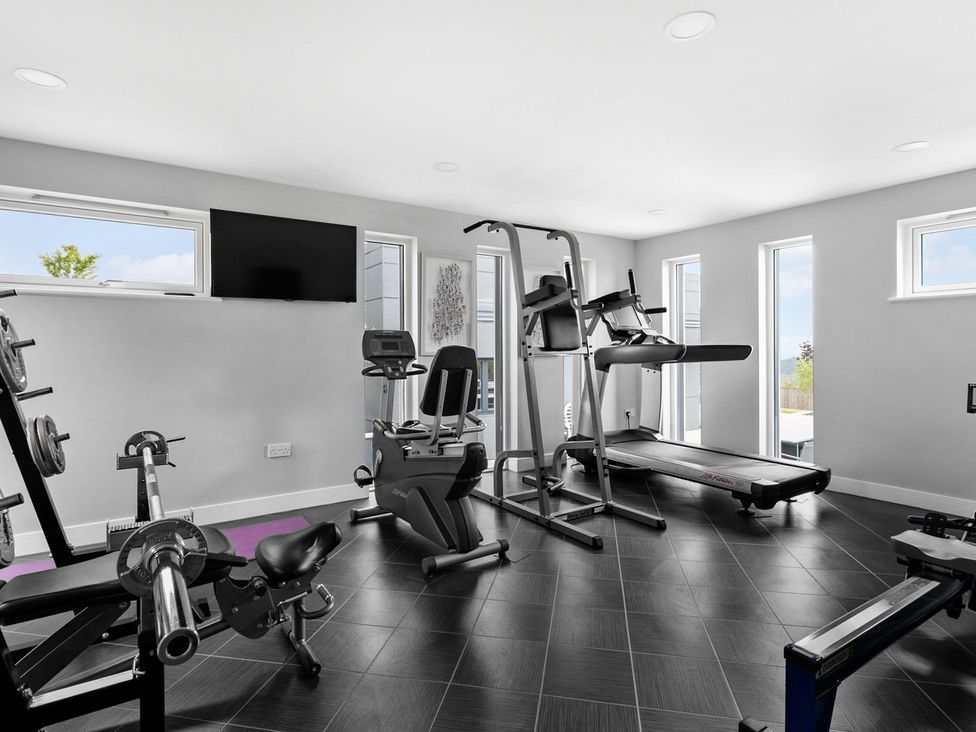 A gym with exercise equipment at Huxham View & Annex in Kingsteignton