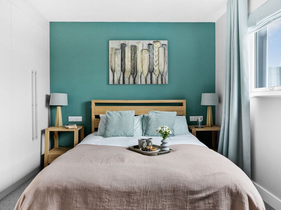 A bedroom with a bed and nightstands at Huxham View & Annex in Kingsteignton