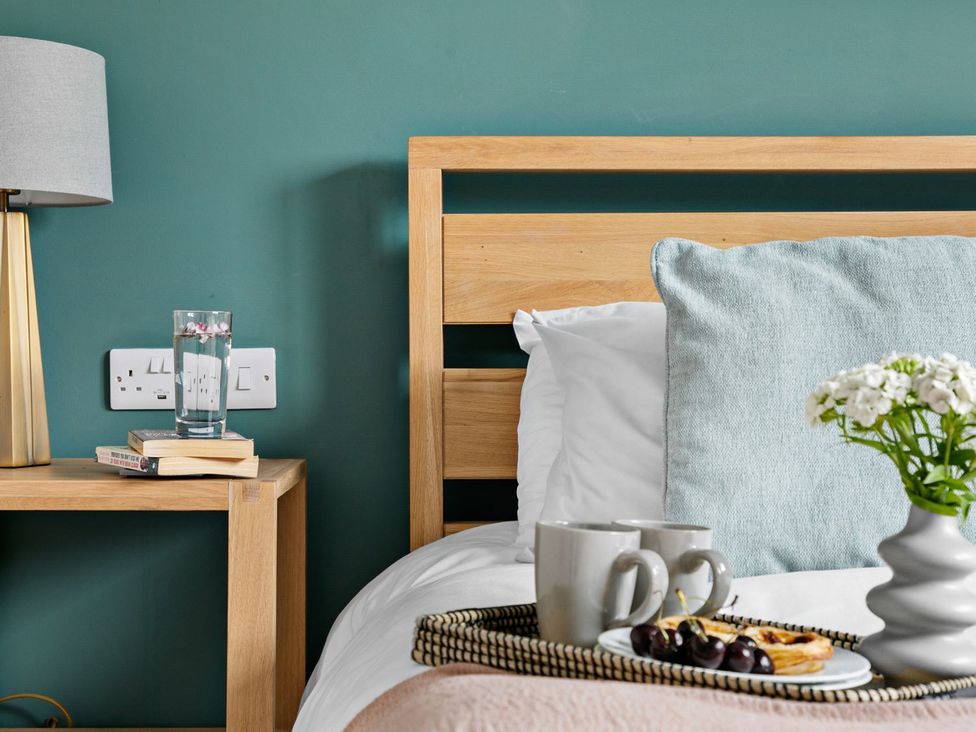 A bedroom with a bed and bedside table at Huxham View & Annex in Kingsteignton