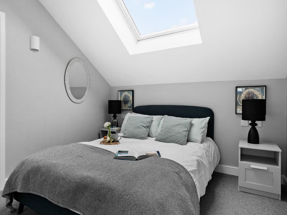 A bedroom with a bed and a nightstand at Huxham View & Annex in Kingsteignton