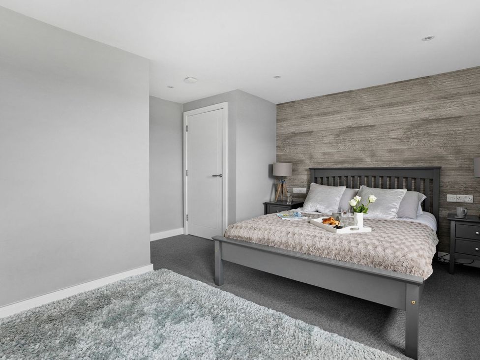A bedroom with a bed and bedside tables at Huxham View & Annex in Kingsteignton