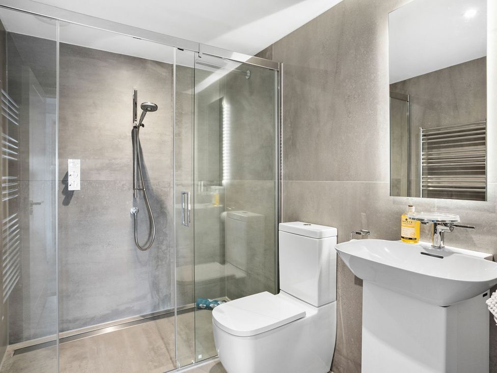 A bathroom with a shower, toilet, and sink at Huxham View & Annex in Kingsteignton