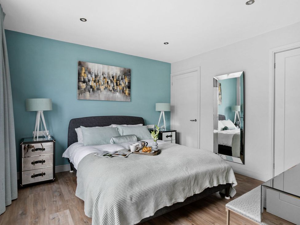 A bedroom with a bed and nightstand at Huxham View & Annex in Kingsteignton
