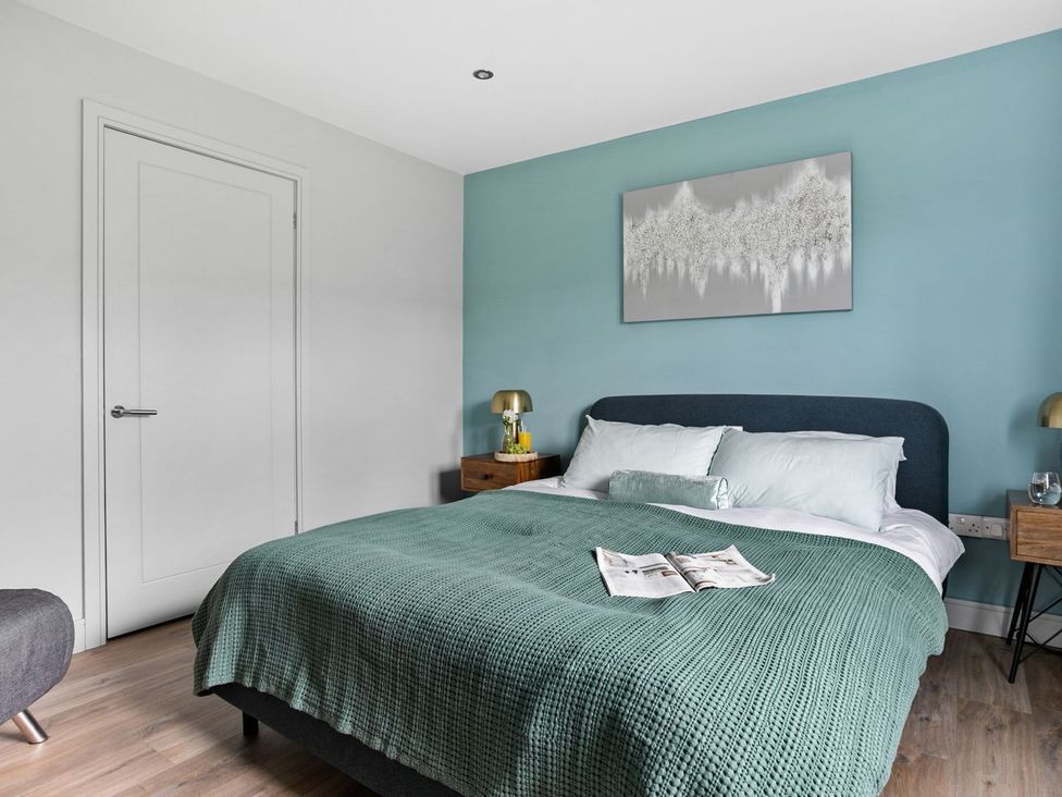 A bedroom with a bed and bedside tables at Huxham View & Annex in Kingsteignton