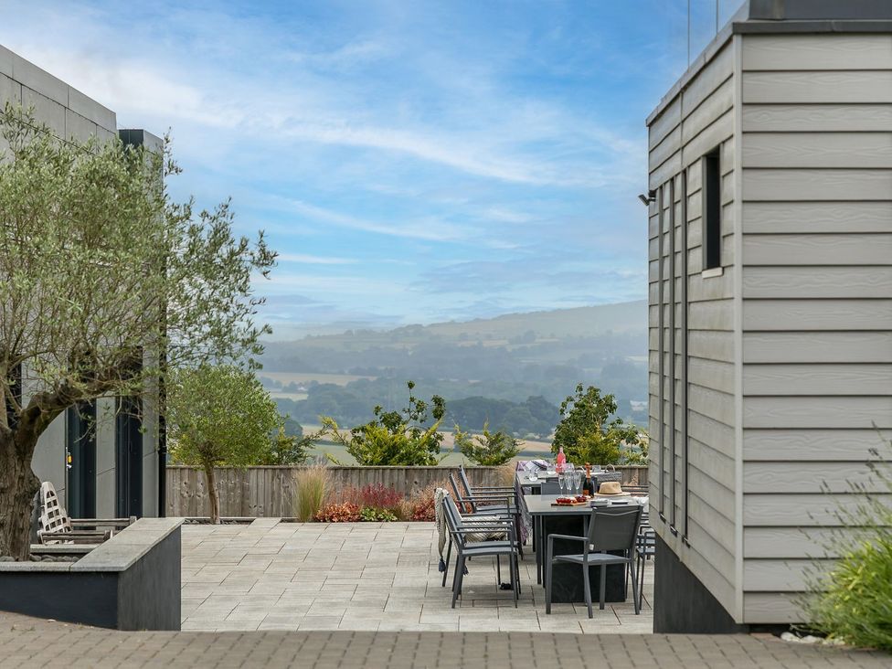 An outdoor patio with seating and a view at Huxham View & Annex Kingsteignton