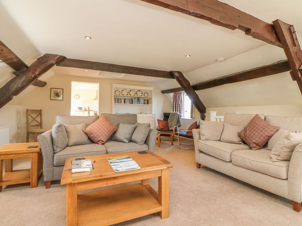 A living room with sofas and a coffee table at Upper Barn Cottage in Minehead