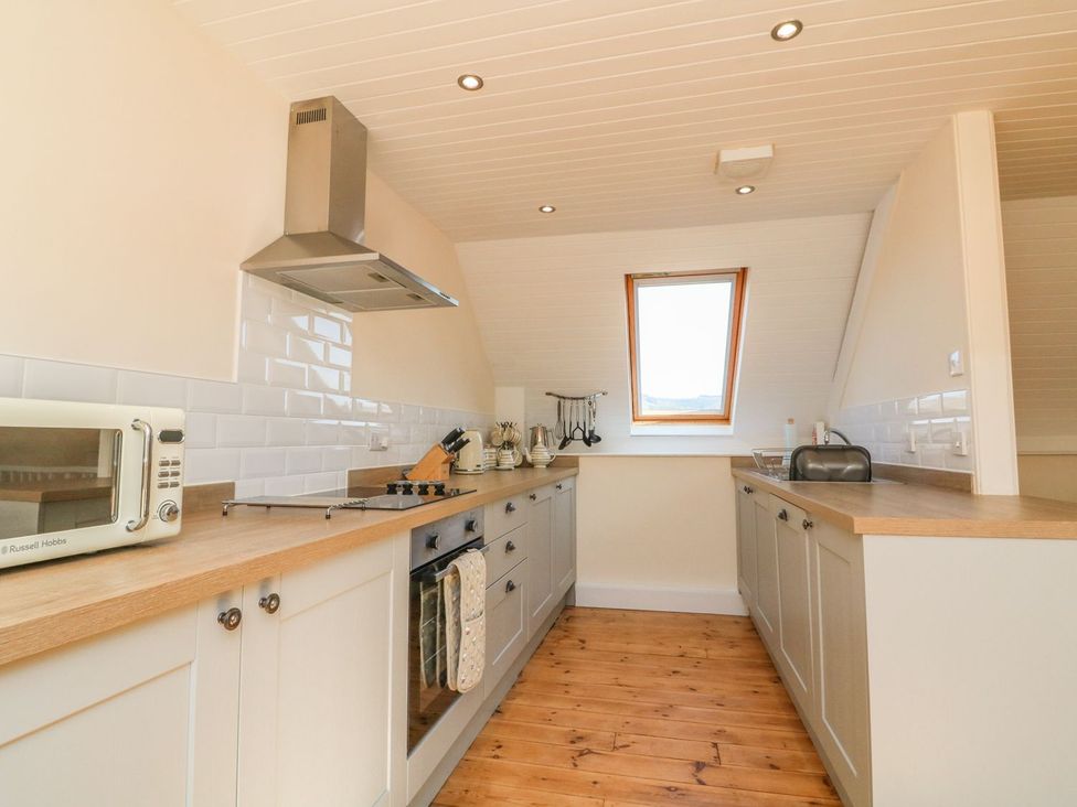 A kitchen with various appliances at Upper Barn Cottage Minehead