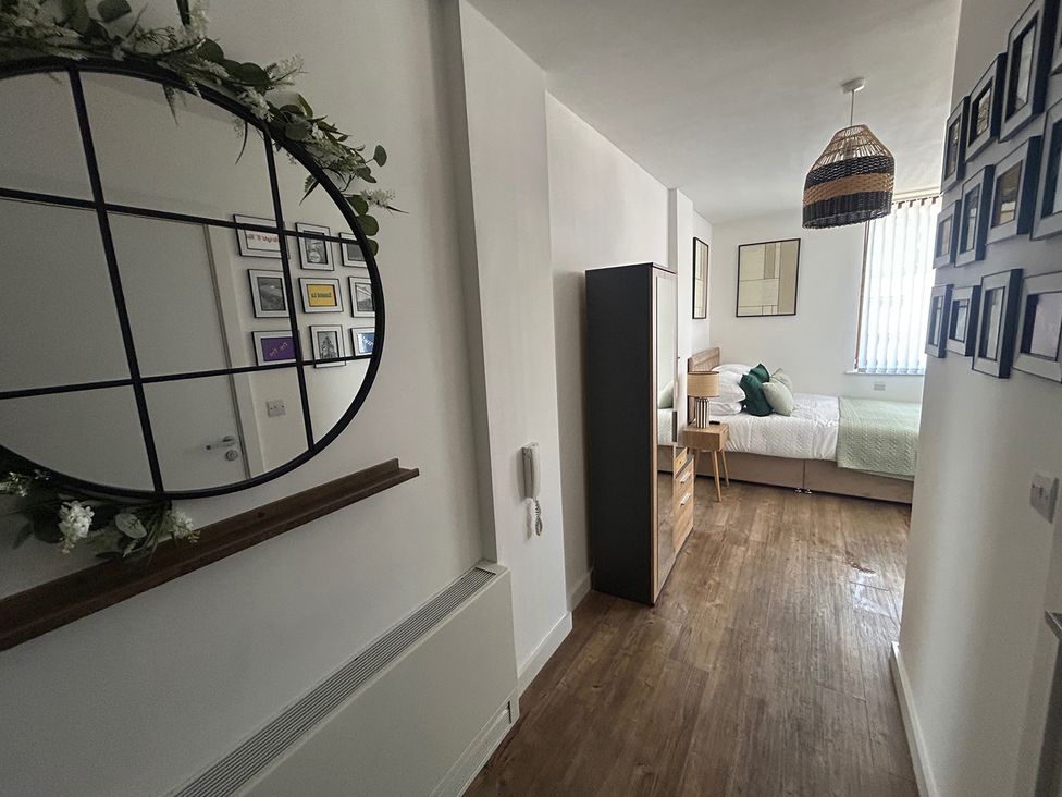 A bedroom with a bed and a desk at 1 Bed Studio, Sleeps 2 with City Views Liverpool
