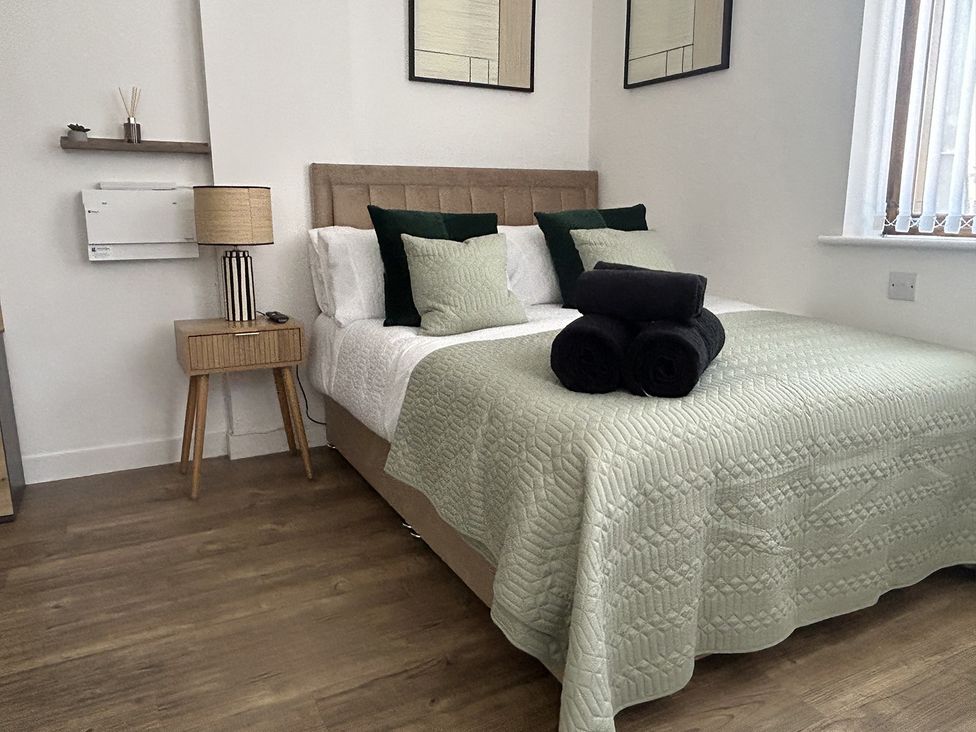 A bedroom with a bed and bedside table at 1 Bed Studio, Sleeps 2 with City Views, Liverpool