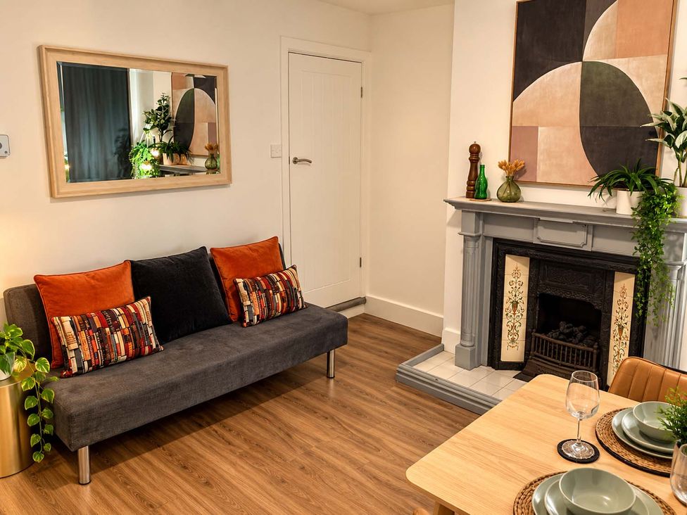 A living room with a sofa, fireplace, and dining table at 2 Bed House in Creswell, Sleeps 7 with Street Parking, Creswell