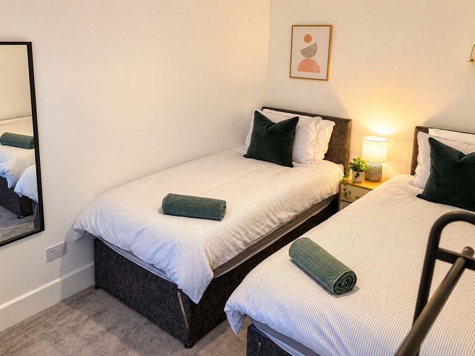 A bedroom with two beds and a mirror at 2 Bed House in Creswell, Sleeps 7 with Street Parking, Creswell