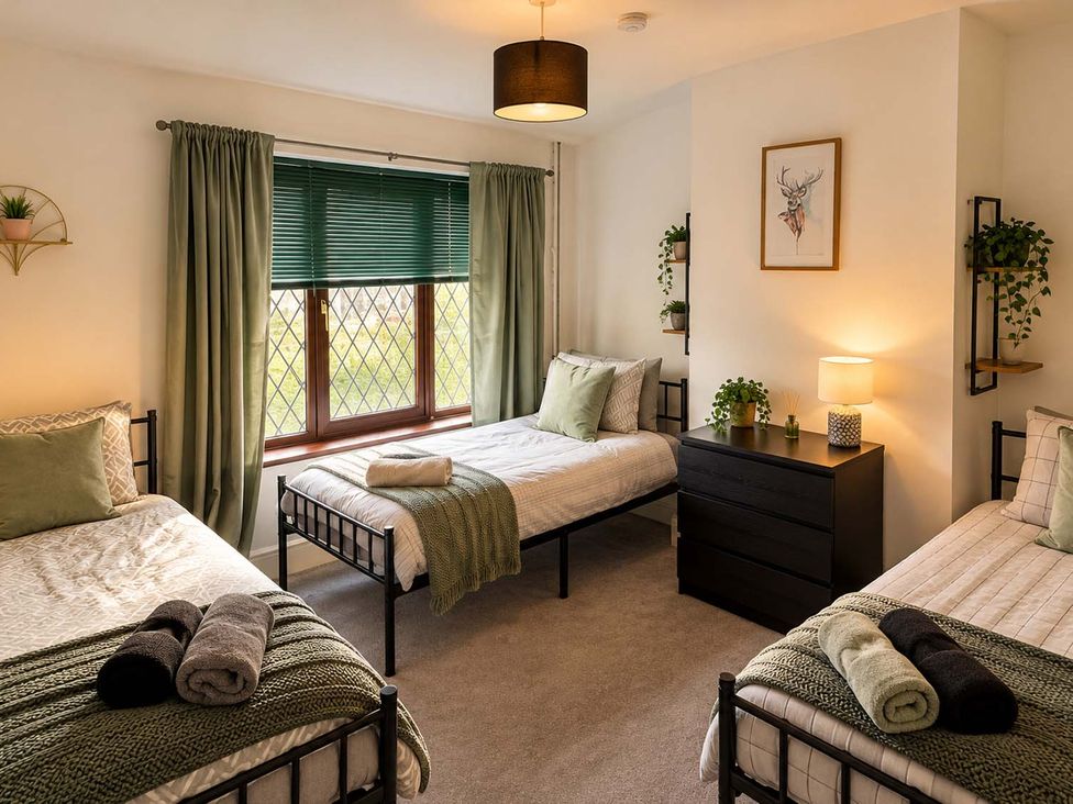 A bedroom with three single beds and a dresser at 2 Bed House in Creswell, Sleeps 7 with Street Parking, Creswell