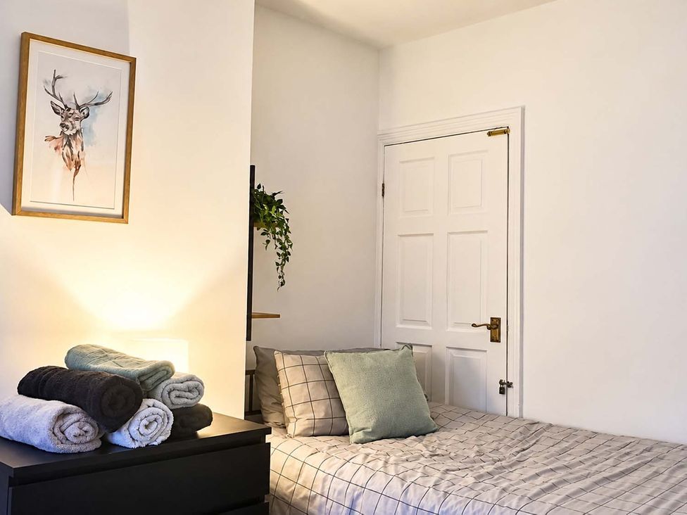 A bedroom with a bed and towels on a dresser at 2 Bed House in Creswell, Sleeps 7 with Street Parking, Creswell