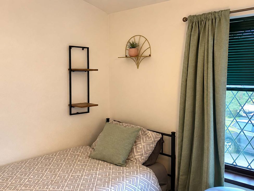 A bedroom with a bed and shelf at 2 Bed House in Creswell, Sleeps 7 with Street Parking, Creswell