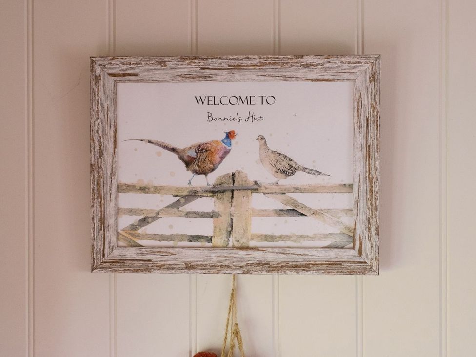 A framed picture of birds and text at Bonnie's Shepherds Hut at Shepherds Lodge Retreat and Wellness Nottingham