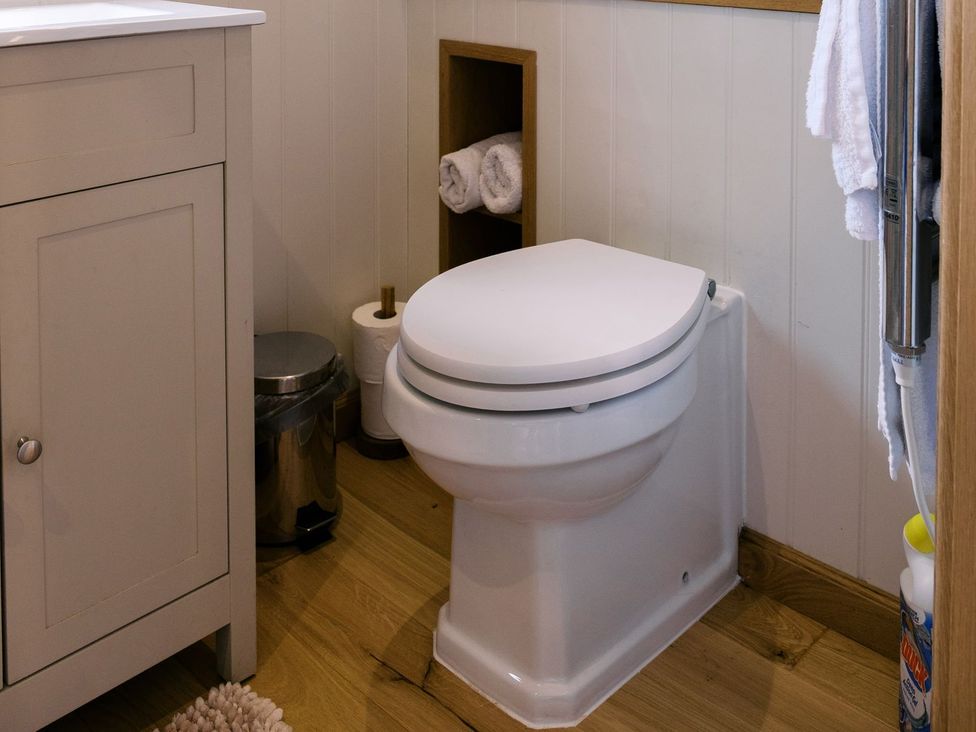 A bathroom with a toilet and sink at Bonnie's Shepherds Hut at Shepherds Lodge Retreat and Wellness, Nottingham