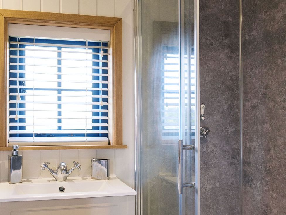 A bathroom with a window, sink, and shower at Lillie's Shepherds Hut at Shepherds Lodge Retreat and Wellness Nottingham