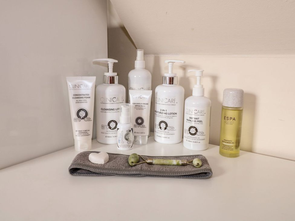 A bathroom counter with skincare products and tools at Herbie's Shepherds Hut at Shepherds Lodge Retreat and Wellness Nottingham