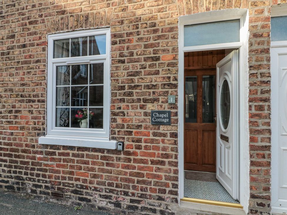 An entrance with a window and door at Chapel Cottage in Filey