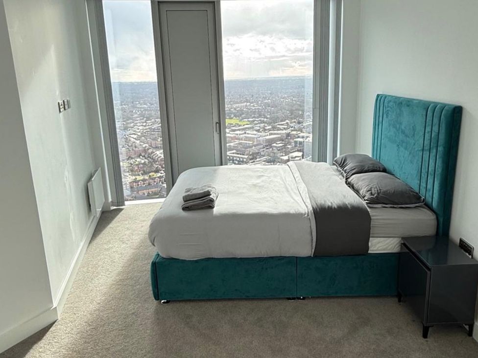 A bedroom with a bed and bedside table at 3 Bed Apartment, sleeping 6 with Wifi in Manchester