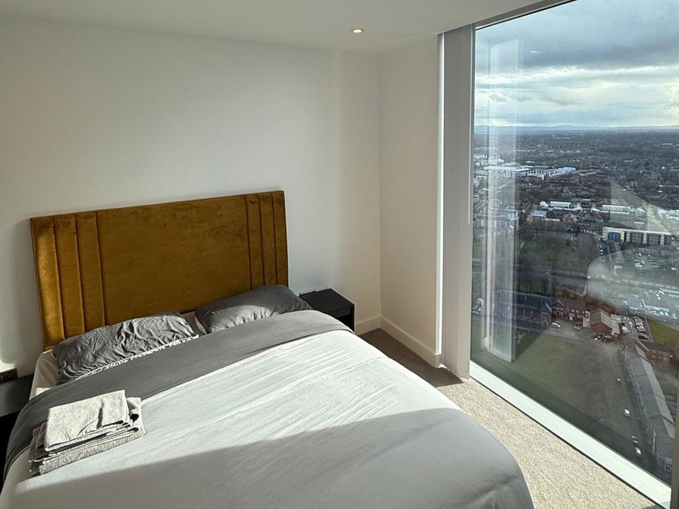 A bedroom with a bed and view at 3 Bed Apartment, sleeping 6 with Wifi in Manchester