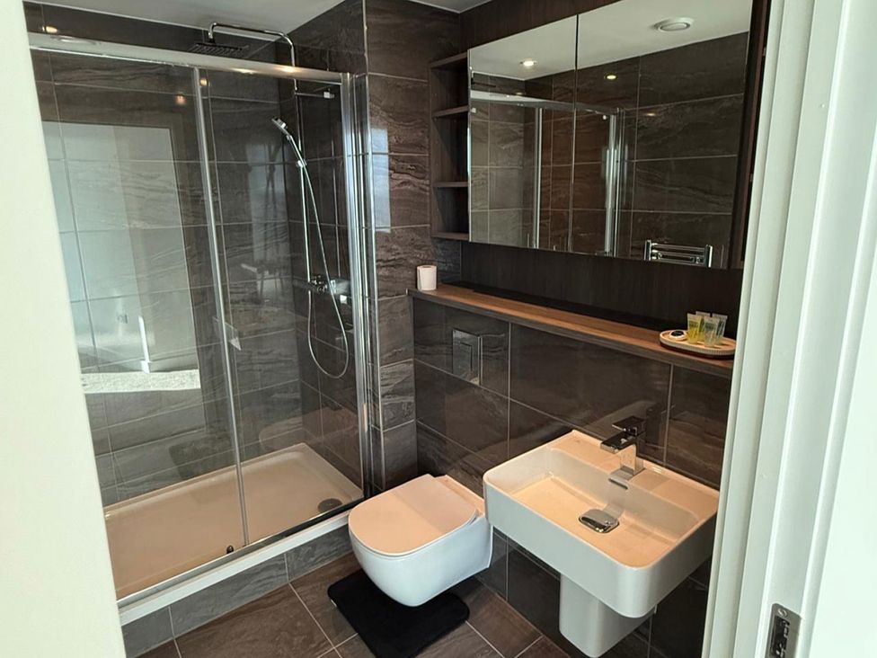 A bathroom with a shower stall, toilet, and sink at 3 Bed Apartment, sleeping 6 with Wifi, Manchester